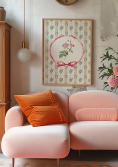 a pink couch sitting in front of a clock on the wall next to a vase with flowers