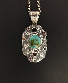 ARTISAN TURQUOISE TOURMALINE PENDANT  Hand-made Sterling Silver 925.  Stones used: Turquoise(Nevada), Green Tourmaline, Pink Tourmaline,   Red Sapphire, Citrine, Amethyst, Garnet.  Height -2 3/4” (including bail), Width – 1 6/16”  Height – 72mm (including bail), Width – 35mmUnique Handcrafted One-of a-kind Design PendantEach Piece of Jewelry in my Collection is Absolutely One of a Kind!When you start wearing a piece of my jewelry you will fall in love with it more and more each day and feel that Unique Turquoise Necklace With Gemstone Accents, Artisan Multi-stone Oval Necklace, Artisan Turquoise Necklace With Round Pendant, Unique Handmade Oval Turquoise Necklace, Handmade Unique Oval Turquoise Necklace, Artisan Turquoise Necklace With Oval Pendant, Artisan Turquoise Necklace With Gemstone Accents, Artisan Turquoise Necklaces With Gemstone Accents, Artisan Oval Turquoise Necklace One Of A Kind