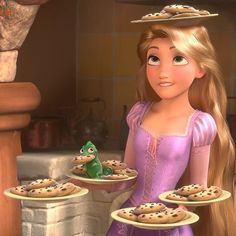 the princess and the frog are holding cookies on trays in front of each other