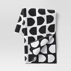 a black and white polka dot pattern folded on top of a table with a napkin