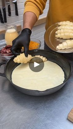 a person in black gloves is making some food