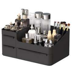 a black container with makeup brushes and other items in it