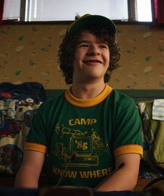 a young boy wearing a green and yellow shirt