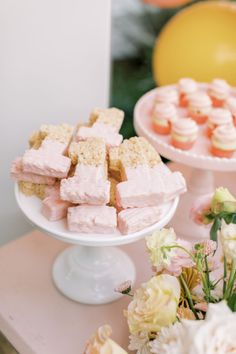 there are many desserts on the table and one has pink marshmallows