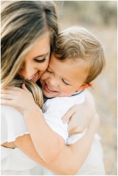 a mother hugging her son on the cheek