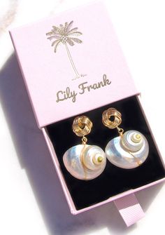 Dive into the mesmerizing allure of our Natural Nautilus Shell Earrings, inspired by the enchanting beauty of the ocean. Each sustainable and reworked shell is adorned with a singular freshwater pearl, reminiscent of treasures found along the shore. Impeccably designed, this one-of-a-kind piece captures the essence of oceanic elegance. Choose your favorite from three distinct post options - whether it's the chic gold knot or the classic gold shell with push backing, or the oval drop with conveni Luxury Shell-shaped Statement Earrings, Luxury Statement Shell-shaped Earrings, Luxury Shell-shaped Earrings As A Gift, Luxury Shell-shaped Earrings For Gift, Luxury Shell-shaped Jewelry, Luxury Gold Shell Earrings, Cheap Elegant Shell Earrings, Luxury Summer Earrings As Gift, Luxury Gift Earrings With Unique Design