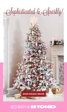 a white christmas tree with pink and blue ornaments