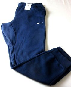 Nike Club Men's Tapered Leg Fleece Lined Jogger pants Midnight Navy Blue NWT Ships Free.  Nike Club Men's tapered leg fleece lined jogger pants.  Brand new with all original tags. "Midnight Navy Blue" in color with 2 front pockets and 1 pocket in the back that snaps.  These pants are standard fitting with tapered leg design and regular length.  Nike Swoosh logo on the front.  Super versatile, lightweight and comfortable, these pants are soft cotton and  Polyester in material.   As always we guarantee authenticity. Nike style # 716830-410.  Fast and Free U.S. shipping to your door.  Please message us with any questions.  Thanks! PLEASE NOTE, WE DO OUR BEST TO MAKE YOUR EBAY BUYING FROM US AS EASY & SMOOTH AS POSSIBLE. IF YOU SHOULD HAVE ANY ISSUES WITH YOUR PURCHASES, PLEASE CONTACT US 1'ST Nike Style, Nike Swoosh Logo, Swoosh Logo, Active Wear Pants, Nike Fashion, Nike Swoosh, Leg Design, Midnight Navy, Tapered Legs