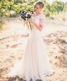 a woman in a wedding dress holding flowers