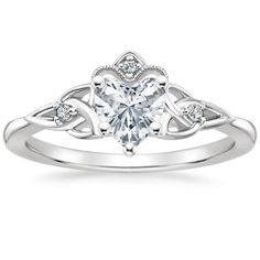 an engagement ring with a heart shaped diamond in the center