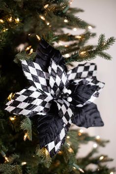 a black and white bow on top of a christmas tree