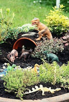 there are many toy dinosaurs in the garden