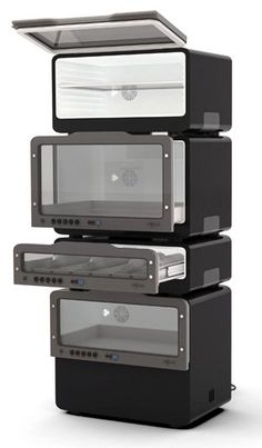 three stacked black and silver microwaves on top of each other with their doors open