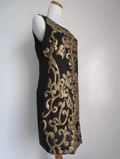 "This is a Glamorous Vintage Modern 1963DEX Made in INDIA Black Polyester and Golden Metallic Gold Sequin Embellished Shift Knee Midi Dress Cocktail Party Evening Special Occasion Size S M The style is a fully lined, shift dress with side invisible zipper, and heavily embellished metallic gold knee sequins front and back (never sit on sequins!). condition there is 1 very tiny hole/cut on the side of the dress, but it's not obvious, only if you stare at it really closely. Other than that, this lo Black Embellished Sheath Dress, Black Embellished Dresses For Festive Occasions, Festive Embellished Black Dress, Festive Black Embellished Dress, Black Evening Dress With Gold Embroidery, Black Dress With Gold Embroidery For Party, Midi Dress Cocktail, Midi Cocktail Dress, Dress Cocktail