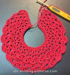 a crocheted doily with a pair of scissors next to it