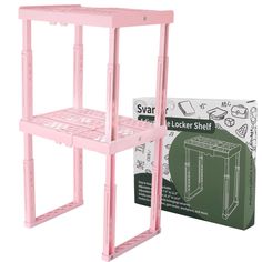 a pink shelf with two shelves on each side and a box for the top one