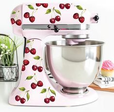 a pink mixer with cherries painted on it