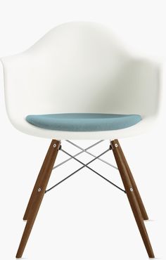 a white chair with a blue cushion on it's seat and two wooden legs