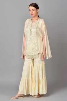 Ivory kurta with sequin work and floral embroidered motifs. Paired with tiered sharara.
Component: 2
Embroidered
Neckline: Round
Sleeve Length: Short
Fabric: Cotton Chiffon, Georgette
Color: White
Front tassel tie-up
Tassel cape sleeves - Aza Fashions Kurta And Sharara Set, Kurta And Sharara, Embroidered Motifs, White Kurta, Cape Sleeves, Sharara Set, Embroidered Neckline, Fashion App, Set For Women