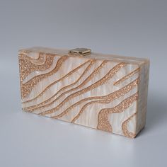 Looking for a stylish and chic statement accessory with a designer touch? You'll love this beautiful Luxury Resort Acrylic Clutch Bag! With its beautiful pearl sheen and its gold design, this stylish acrylic clutch bag won't go unnoticed. Simple and chic, it's the perfect accessory to dress up an outfit for a luxury resort feel. To wear on your way to the cocktail bar, the beach or by the pool, this beautiful acrylic clutch bag is perfect for all occasions and the holiday season! Style: Eclectic Trendy Beige Evening Bag As Gift, Trendy Beige Evening Bag For Gift, Luxury Beige Rectangular Clutch, Beige Rectangular Evening Bag With Pearl Handle, Beige Clutch With Pearl Handle For Party, Party Clutch With Pearl Handle In Beige, Trendy Beige Rectangular Evening Bag, Glamorous Beige Clutch Evening Bag, Beige Rectangular Clutch With Pearl Handle