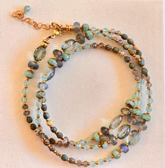 Thisulti purpose piece has many high end gemstones, aqua marine, turquoise, labradorite, green amethyst, all the findings and chain is made with gold fill This bracelet/necklace is 21 inches long with an adjustable clasp and chain to fit all sizes, the bracelet will wrap around the wrist 3 times. Turquoise Multi-strand Wrap Bracelet As Gift, Turquoise Multi-strand Hand Wrapped Bracelet, Adjustable Aquamarine Beaded Bracelets With Natural Stones, Adjustable Aquamarine Beaded Bracelet With Natural Stones, Adjustable Aquamarine Bracelets With Natural Stones, Adjustable Beaded Aquamarine Jewelry, Turquoise Multi-strand Hand Wrapped Jewelry, Turquoise Multi-strand Wrap Bracelet, Adjustable Amazonite Gemstone Beads Jewelry