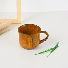 a wooden cup sitting on top of a white table