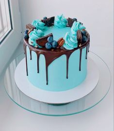 a cake with blue frosting and chocolate toppings