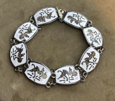 Add a touch of vintage charm to your jewelry collection with this beautiful Siam panel bracelet. The bracelet features a stunning white enamel design with a Siam dancer theme and is made from high-quality silver material. Measuring 7.5 inches in length x 1/2", this bracelet is the perfect accessory for any occasion. Weighs 16.3g Silver Material, White Enamel, Chain Link Bracelet, Vintage Charms, Link Bracelets, Chain Link, White Vintage, Bangle Bracelets, Gifts For Kids