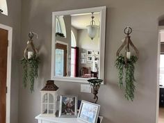 a white dresser sitting under a mirror next to a doorway