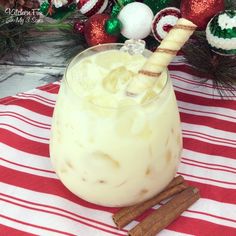 a glass filled with ice cream sitting on top of a red and white table cloth