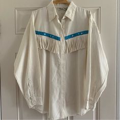 This Is A Quality Vintage Shirt With Super Fun Details. Who Doesn’t Love Fringe? It Is A Unisex/Men’s Size Medium/Women’s Size Large. Excellent Condition With A Few Very Small Stains Noted In Photos. A White Shirt Is Always Classic. The Trim And Fringe Make This A Stand Out! Blue Shirt For Spring Rodeo, Blue Shirt For Rodeo In Spring, White Top For Rodeo Summer Events, White Relaxed Fit Tops For Rodeo, Long Sleeve Tops For Summer Rodeo, Oversized Tops For Rodeo In Spring, White Tops For Summer Rodeo, Summer Long Sleeve Tops For Rodeo, White Summer Tops For Rodeo