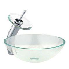 a glass bowl sink with a chrome faucet