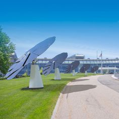 several solar panels are placed on top of white cones in the middle of a grassy area