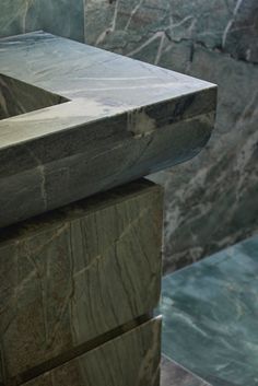 a marble sink in the middle of a room