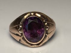 "Very sweet antique purple sapphire ring in 14K rosy gold. This pretty ring features an oval cut purple sapphire (origin unknown) in a classic Victorian bezel mount. The top of the ring measures 14.5mm and the sapphire measures 11.8x9.3mm. The sapphire appears to be original to the ring and has no chips or cracks. Mounted in a very solid mount with a solid back. Lovely Victorian decorative details to the sides and going down the ring shank. This is a solid piece at 5.7 grams. Ring size 7 and eas Formal Purple Oval Ruby Ring, Classic Purple Signet Ring, Oval Purple Sapphire Ring In 14k Gold, Oval Amethyst Ring, Purple Sapphire Ring, Opal Solitaire Ring, Saphir Ring, Pretty Ring, Ring Shank