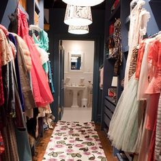 the closet is full of clothes and dresses