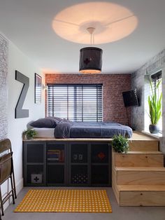 a bed sitting on top of a wooden floor next to a window