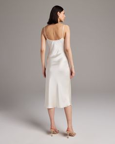 Bias cut Midi Slip Dress elegantly drapes on the body. This perfect basic can be worn for life, dressed up, or dressed down, for the perfect ensemble. Style with a sweater and boots in the Fall or wear with sandals in the Summer. 100% Silk Charmeuse Made in New York City Product Care: Dry Clean Only Fitted Midi Slip Dress For Daywear, Classic Silk Midi Slip Dress, Classic Silk Midi-length Slip Dress, Elegant Mid-length Midi Dress For Daywear, Elegant Fitted Silk Dress For Daywear, Elegant Fitted Silk Daywear Dress, Elegant V-neck Silk Dress For Daywear, Classic Fitted Midi Slip Dress, Fitted Slip Dress For Daywear