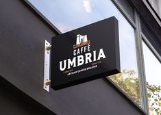 a sign hanging from the side of a building that says i am caf umbria