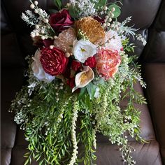 a bouquet of flowers sitting on top of a couch