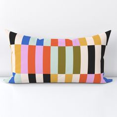 a multicolored pillow sitting on top of a white table