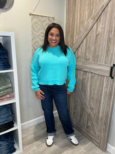 "Get cozy in style with this Aqua Blue Pullover Knit Mock Neck Sweater! Its cropped and oversized fit will keep you both warm and on-trend. Perfect for pairing with high-waisted jeans and boots for a relaxed yet chic look.(No itchy necks here!) Sizing is true to size, I'm in a size large for the perfect cozy feel. Blue Cropped Sweater With Ribbed Cuffs For Fall, Oversized Trendy Cropped Sweater, Casual Cozy Fit Cropped Sweater With Ribbed Cuffs, Trendy Relaxed Fit Cropped Sweater For Winter, Casual Cropped Sweater With Relaxed Fit For Fall, Casual Relaxed Fit Cropped Sweater For Fall, Trendy Cropped Sweater For Fall Loungewear, Casual Soft Knit Cropped Sweater For Fall, Trendy Cropped Relaxed Fit Sweater