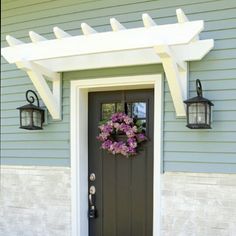 the front door is decorated with flowers and lanterns