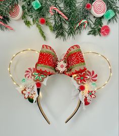 a mickey mouse ears with candy canes and christmas decorations