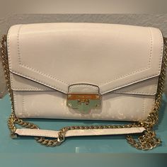 Michael Kors White Shoulder Bag Snap Fastening Everyday Cream Bag With Chain Strap, Evening Bags With Branded Hardware In Cream, Chic Pouch Satchel With Branded Hardware, White Flap Clutch Bag For Shopping, Cream Evening Bags With Branded Hardware, White Travel Clutch With Adjustable Strap, Chic Clutch Shoulder Bag With Branded Hardware, Chic Branded Clutch Shoulder Bag, Everyday White Flap Clutch Bag