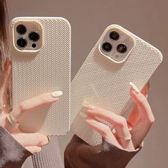 two women holding up their iphone cases