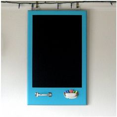 a blue framed chalkboard mounted to a wall