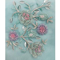 an embroidered piece with flowers and leaves on a light blue background is featured in this image