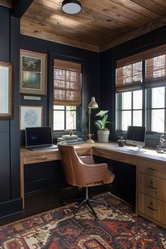 a home office with wooden paneling and black walls, along with a rug on the floor