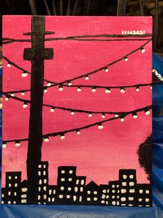 an acrylic painting of a city skyline with lights strung in pink and black